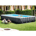 Intex 24ft x 12ft x 52in Ultra XTR Frame Rectangular Swimming Pool Set with Sand Filter Pump, Ladder, Ground Cloth, Cover and Robot Vacuum